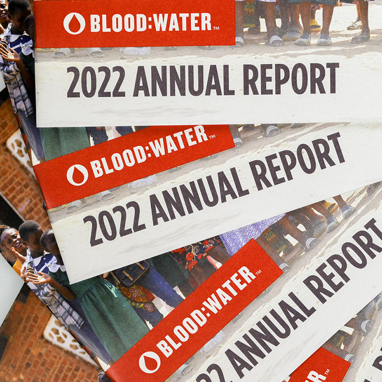 Blood Water annual report booklets with bold red branding and nonprofit publication printing